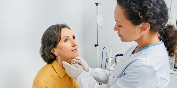 Doctor checking for signs of thyroid cancer