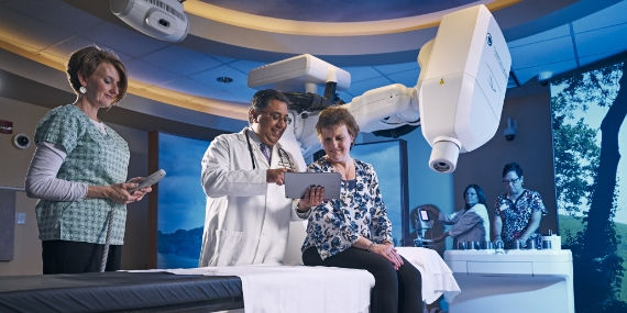 Doctor showing results of cyberknife to patient