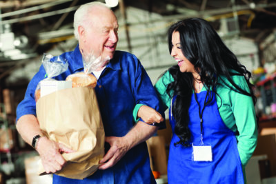 elderly man with food and worker