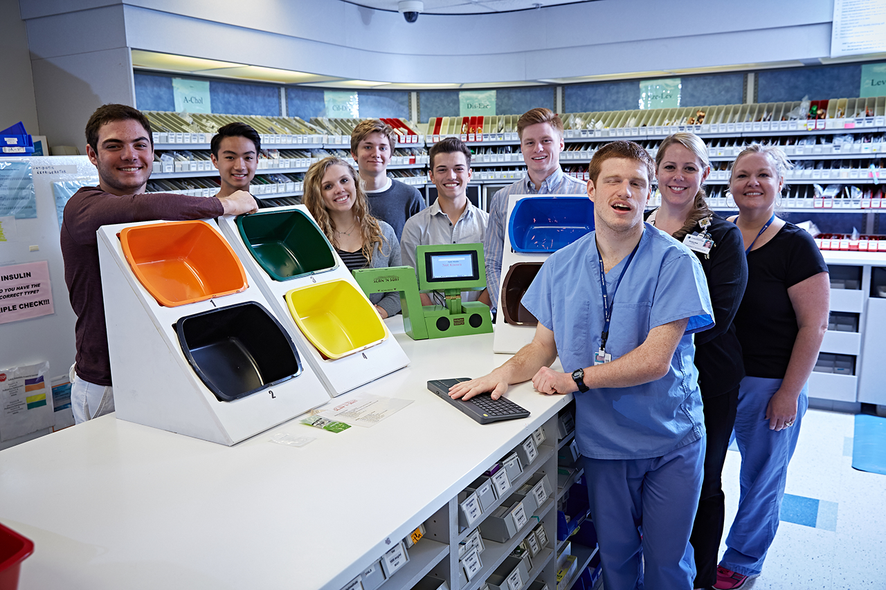 Several members of the Project SEARCH program pose at a sorting desk