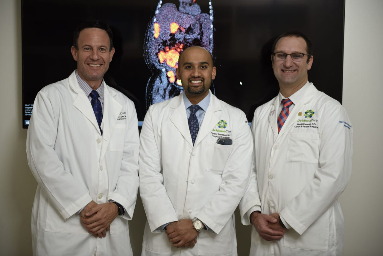 Three doctors smiling at the camera