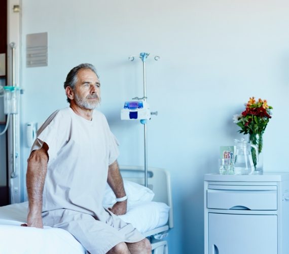 Man sitting up on hospital bed
