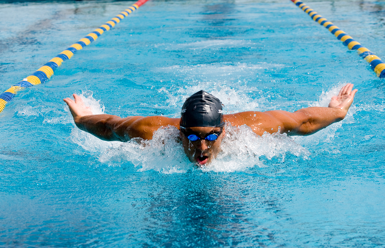 A man competing in a breast stroke swimming race