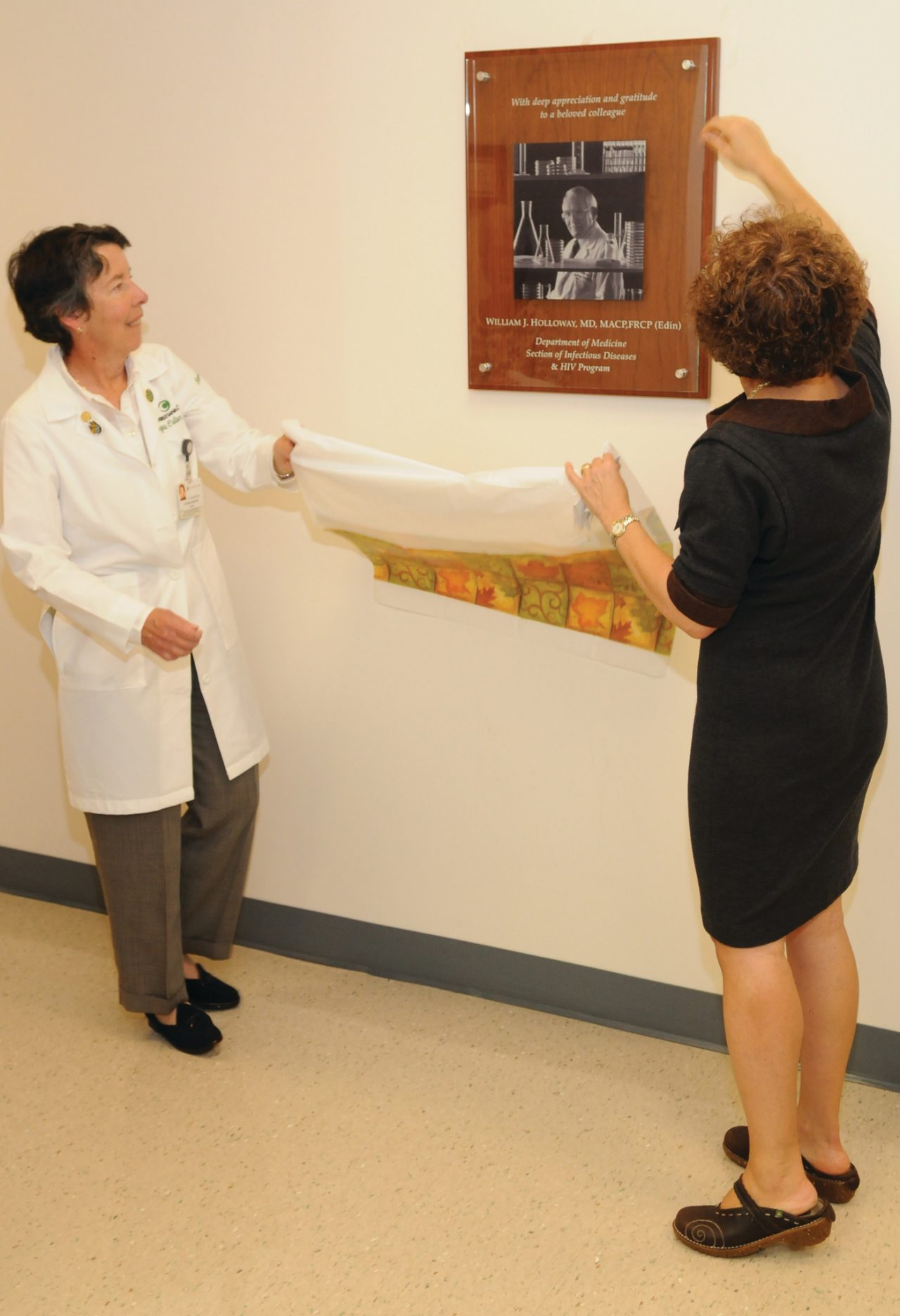 A plaque is unveiled honoring Dr. William Holloway with ChristianaCare's HIV Program