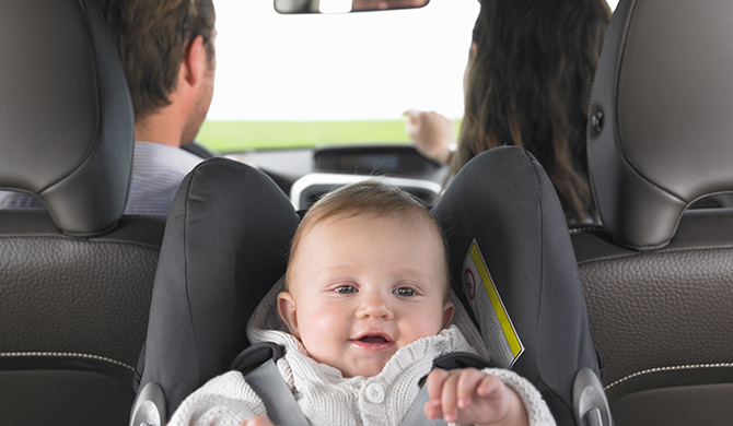Baby in car seat in back of car