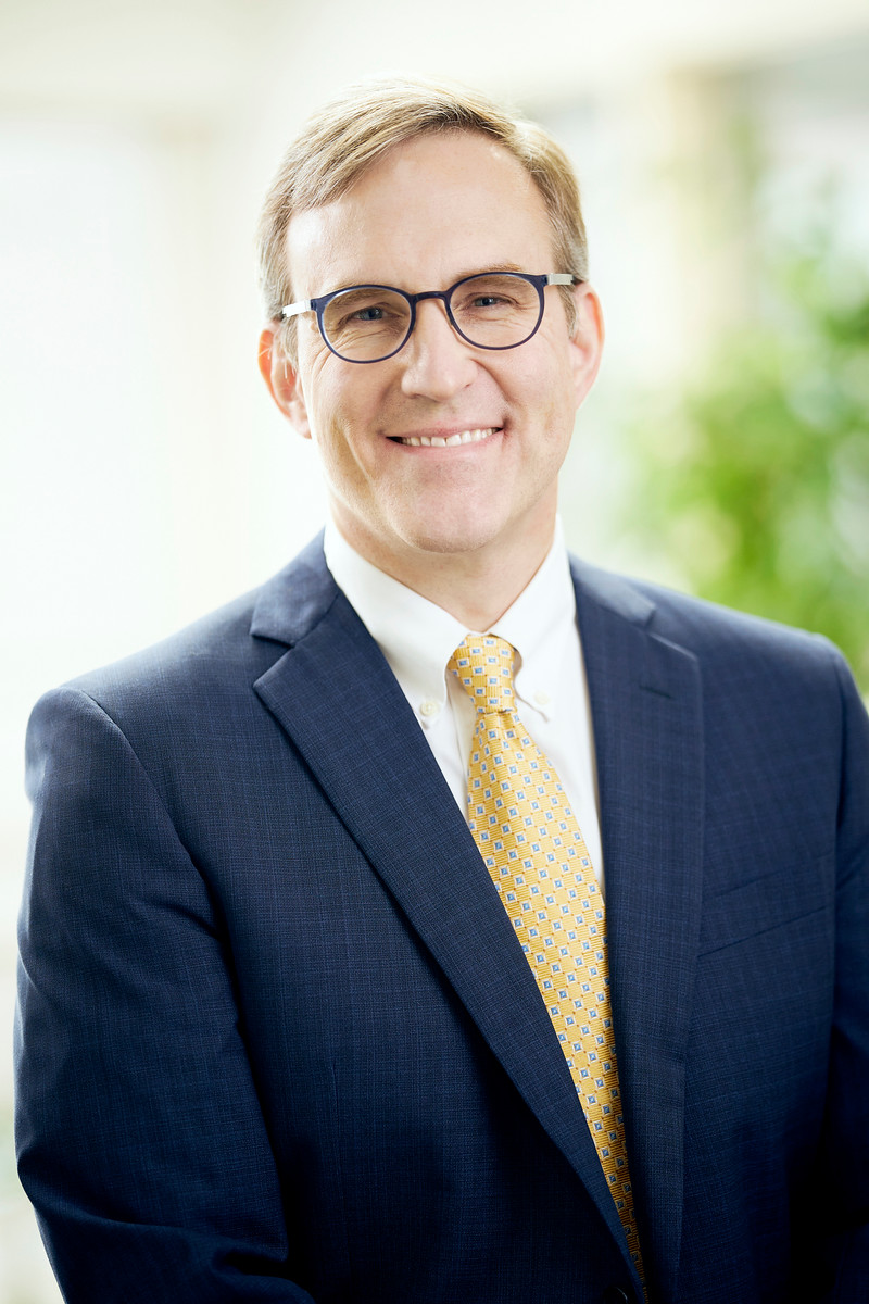 Smiling man in a suit with glasses