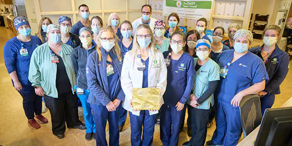 ChristianaCare's Medical Intensive Care Unit poses with their Beacon Award