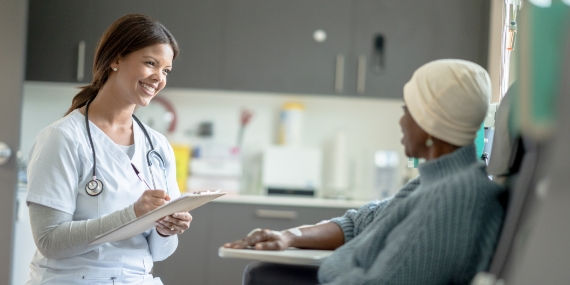 Cancer patient discussing treatment with nurse