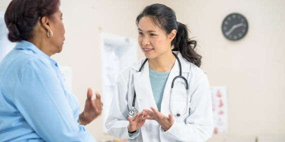 Woman discussing support with doctor