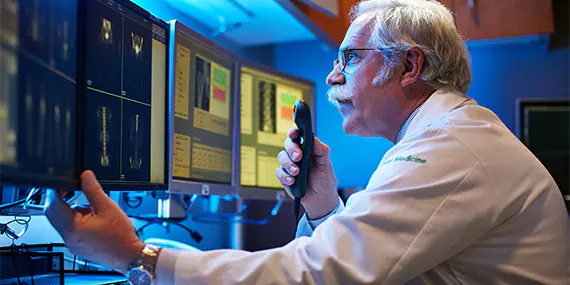 Doctor examining scans on computer screen