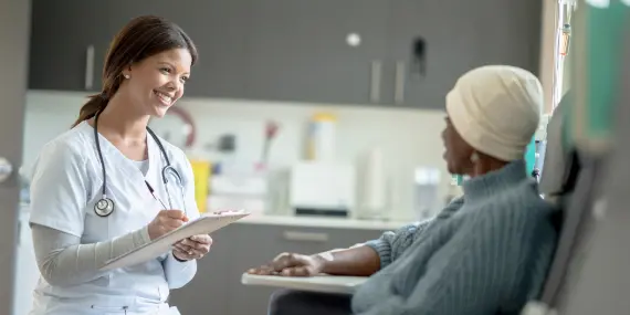 Cancer patient discussing treatment with nurse