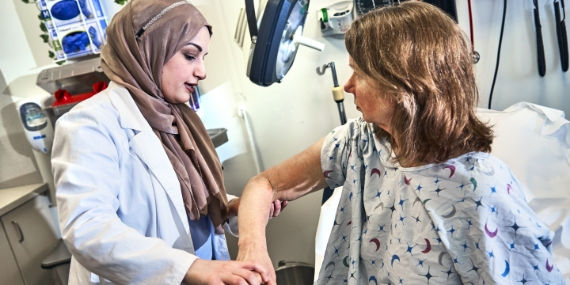 Nurse checking skin of patient