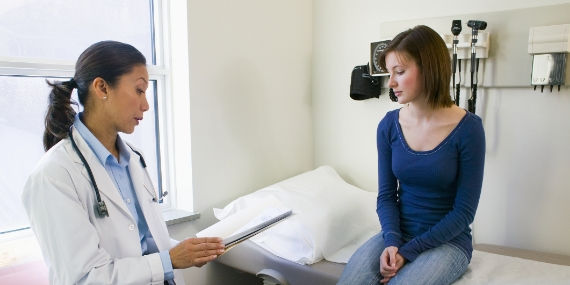 Young woman getting checkup at doctors appointment