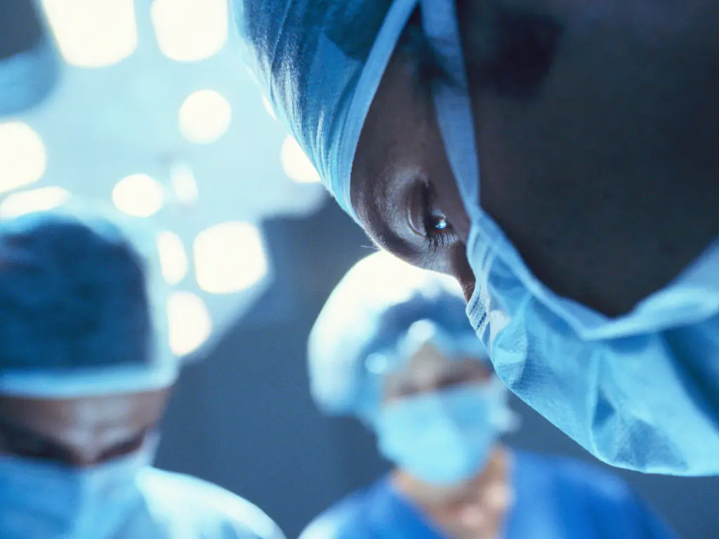 Group of surgeons faces during an operation