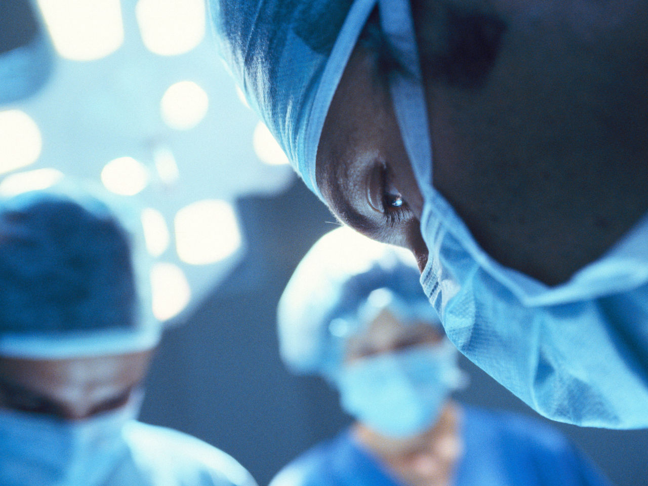 Group of surgeons faces during an operation