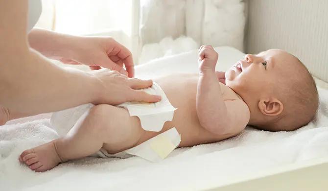 Nappy being put on a baby