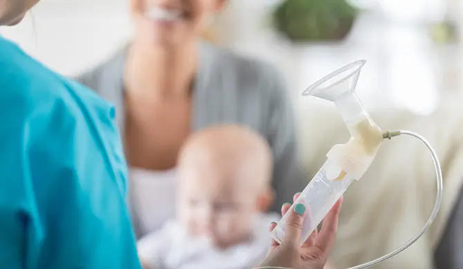 Nurse holding lactation aid device
