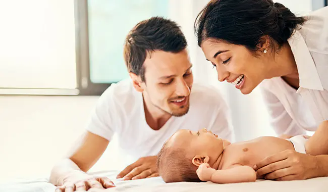 A couple doting over their baby