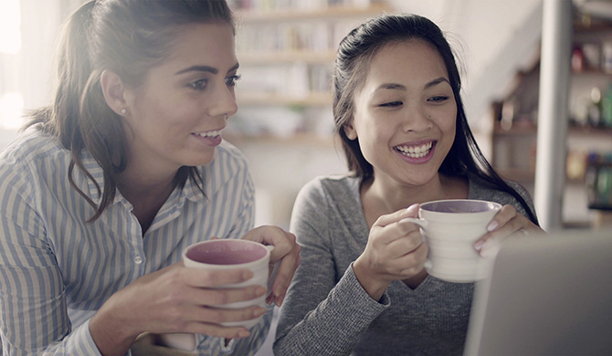 Two women holding cups