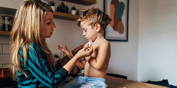 A mother tends to her sick child