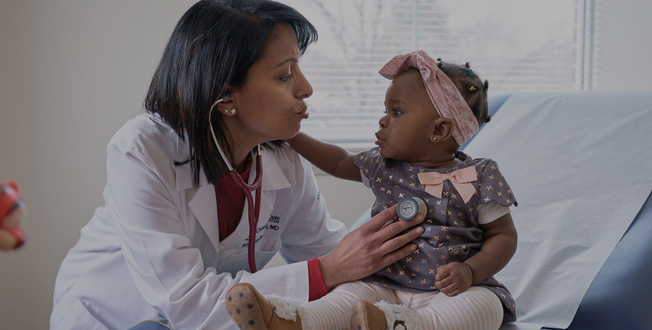 A provider using a stethoscope on a small child 