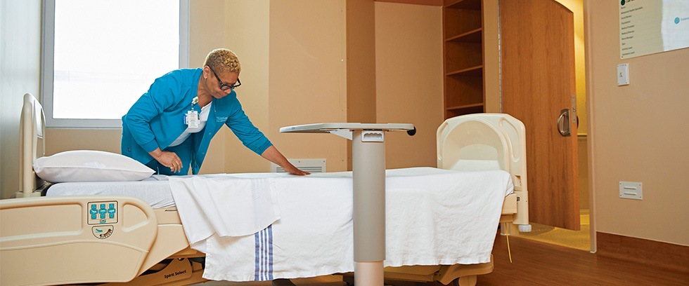 Nurse making patient bed