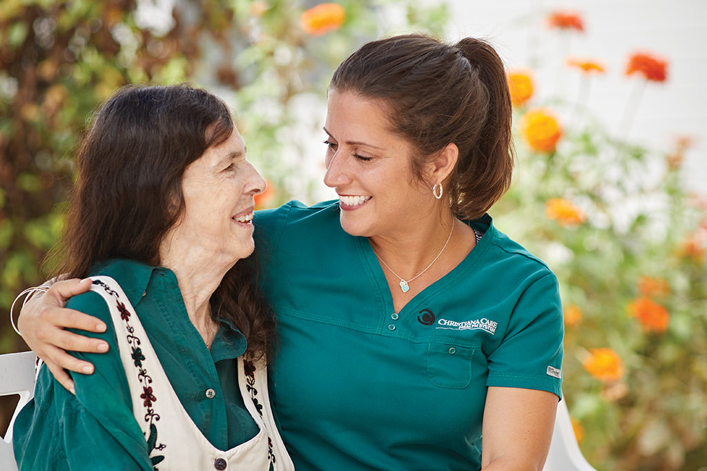 Nurse and patient smiling at each other