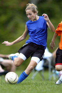 teen girl playing soccer