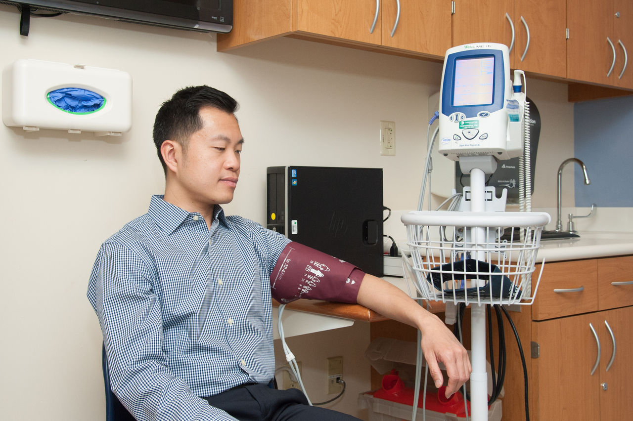 Man undergoing blood pressure measurement in clinic
