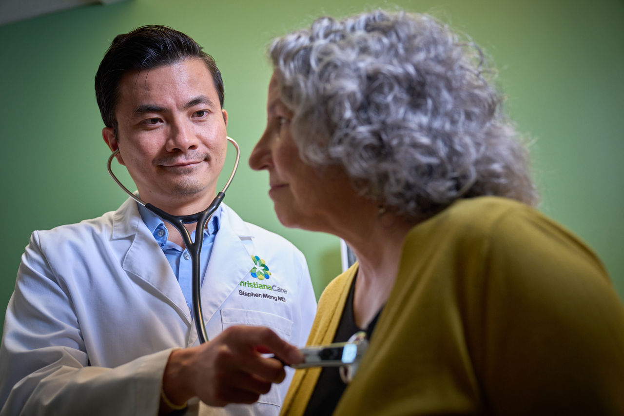 Dr. Stephen Meng of the ChristianaCare Advanced Lipid Clinic examines a patient
