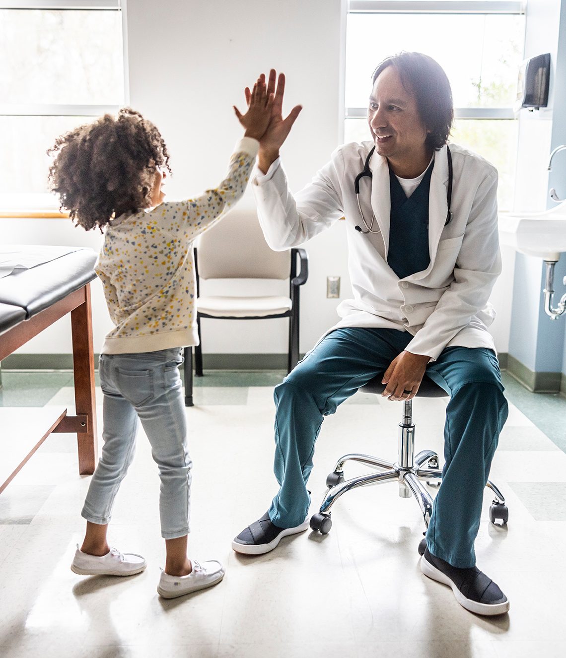 Doctor high fiving child