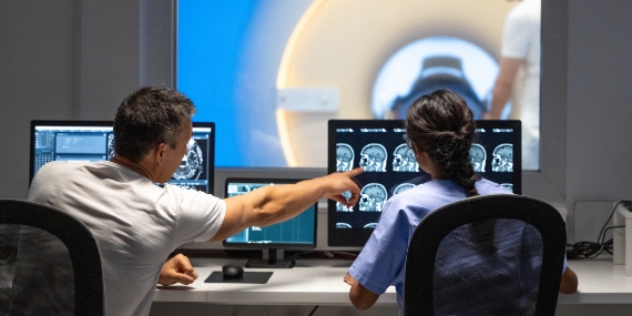 Doctor's and resident examining MRI's