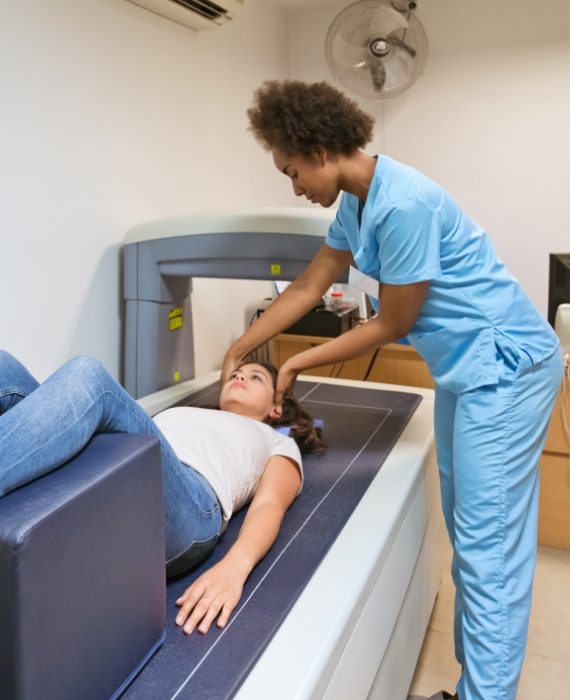 Nurse preparing woman for bone density scan