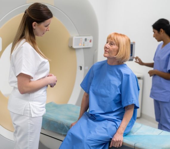 Doctors Preparing Patient For MRI Scan