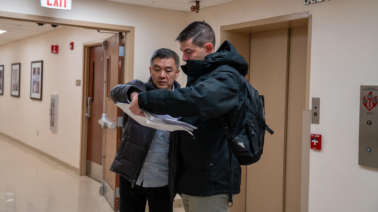 Planners study blueprints for ChristianaCare West Grove Campus during an on-site visit