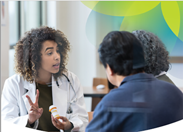 A medical professional holds a medicine bottle and holds up two fingers while speaking to two patients