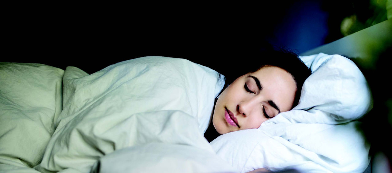 A young woman sleeping in her bed