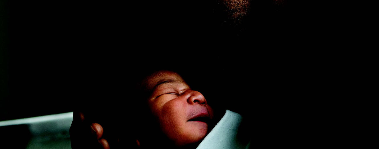 A baby being kissed be its father