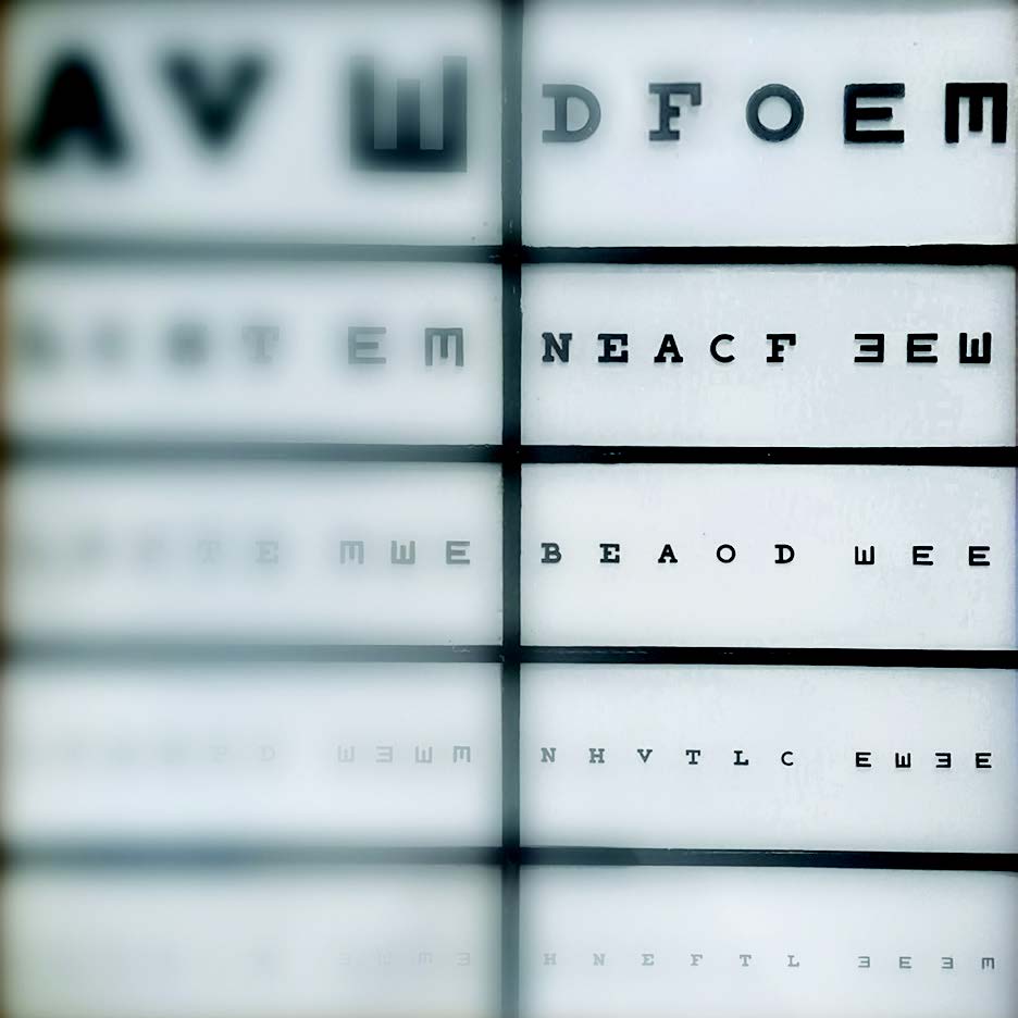 Two columns of eye charts; the one on the left is blurry and very difficult to read.