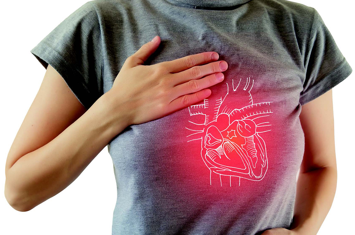 A woman stands with her hand on her chest with a drawing of her internal organs overlaid on her