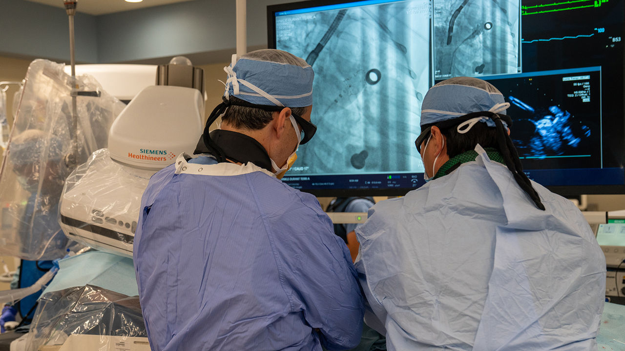 Doctors perform an LAAO procedure in an operating room