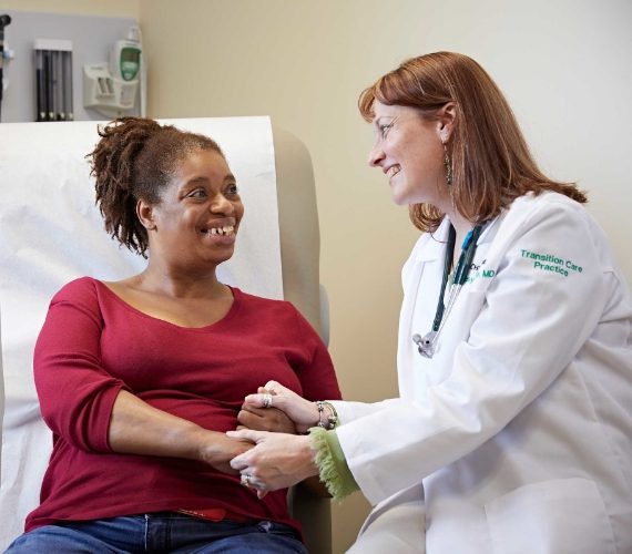 Doctor talking to patient in doctor's office