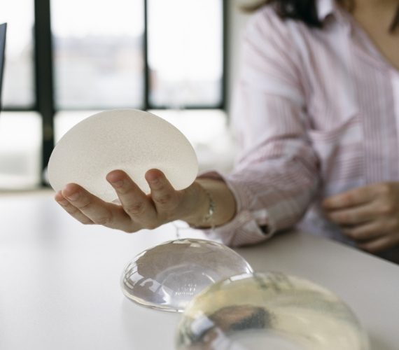 Patient holding breast implants