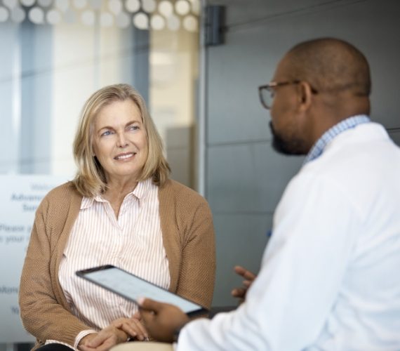 Woman listening to doctor in hospital